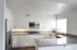Villas at La Costa updated kitchen with stainless steel appliances and wood-style vinyl plank flooring and grey stone countertops