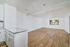 living room and kitchen with vinyl plank wood flooring and large window