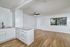 living room and kitchen with vinyl plank wood flooring and large window