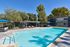 sparkling resident pool with loungers and tables