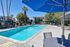 sparkling resident pool with loungers and tables