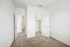 Bedroom at Paseo Village with carpet and a walk in closet