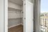 Walk-in closet with shelving and handing rods and hardwood floors