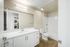 Bathroom at breeze hill with white counters and cabinets and washer and dryer