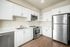 Kitchen at Breeze Hill with white cabinets, counters and stainless steel appliances