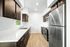 Kitchen at Creekside with dark cabinets with quartz countertops and silver appliances