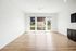 Living room/Dining room with hardwood floors and dark cabinets