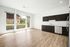 Living room/Kitchen with hardwood floors, large windows and quartz countertops