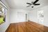 living space with window and ceiling fan and wooden floor