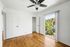 bedroom with wooden floor, ceiling fan, and patio