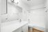 bathroom with mirror, sink, and tub