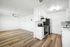 open plan kitchen with appliances and wooden floor