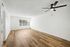 living area with wooden floor, window, ceiling fan