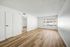 living area with wooden floor, window, ceiling fan