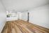 living area with wooden floor and kitchen