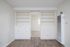 living room with built in bookcase and faux wood flooring at at Avaz Pacific Beach