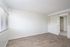 living room with built in bookcase and faux wood flooring at at Avaz Pacific Beach