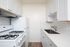 galley style kitchen with white appliances at Avaz Pacific Beach