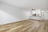 living area with kitchen, ceiling fan, wooden floors, and entrance
