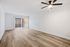 living area with wooden floors, patio, and ceiling fan