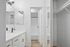 bathroom with mirror, sink, tub, and lighting