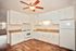 kitchen with white appliances and cabinets and vinyl wood like flooring at Solaris on University