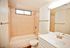 full bath with shower tub combo and white vanity at Solaris on University