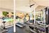fitness center with exercise equipment and windows overlooking pool at Silver Creek Apartments