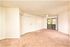 living room with brown carpet and ceiling fan and sliding door to patio at Silver Creek Apartments