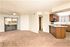 living room with brown carpet and kitchen with peninsula and brown cabinets at Silver Creek
