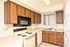 kitchen with vinyl flooring and white appliances and brown cabinets at silver creek