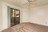 living room with brown carpet and ceiling fan and sliding door to patio at Silver Creek Apartments