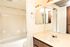 full bath with shower tub combo and beige vanity at silver creek