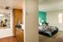 bedroom with green accent wall and furnished with bed and nightstands at metro on main