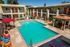 second story view of pool with lounge chairs and poolside cabana at Solaris at The Biltmore