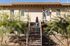 rear of 2 story apartment building with woman climbing the staircase  at oasis 20