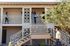 2 story apartment building with woman walking down staircase holding dog at oasis 20