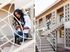 split image of woman sitting on staircase holding dog and walking down staircase at oasis 20