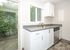 kitchen with stainless steel appliances, tile flooring, and patio door