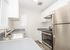 kitchen with stainless steel appliances, tile flooring, and patio door