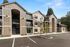 Exterior photo of building with adjacent parking spaces