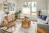 living room with vinyl wood like flooring a grey sofa with a round coffee table and arm chairs on each side and a large rectangular rug