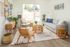 living room with vinyl wood like flooring a grey sofa with a round coffee table and arm chairs on each side and a large rectangular rug