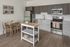 open kitchen with stainless steel appliances and vinyl wood like flooring at twelve mile crossing