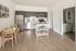 open kitchen with stainless steel appliances and vinyl wood like flooring at twelve mile crossing