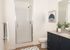 full bathroom with shower with glass door and blue cabinets at twelve mile crossing