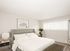 rendering of bedroom with bed and side tables and brown carpet at 81 powell apartments
