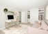 virtually staged image of bedroom with pink sofa and small desk at 81 powell apartments