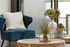 blue chair and pair of round coffee tables