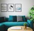 blue sofa with accent pillows and 3 art frames behind on the wall